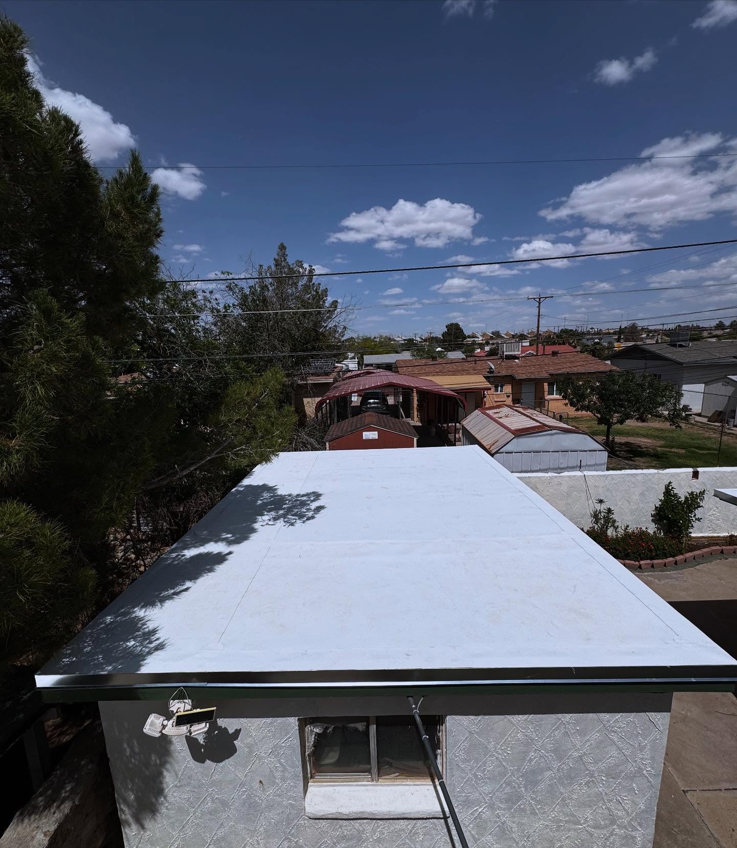 Roofer making shingle repair on El Paso home